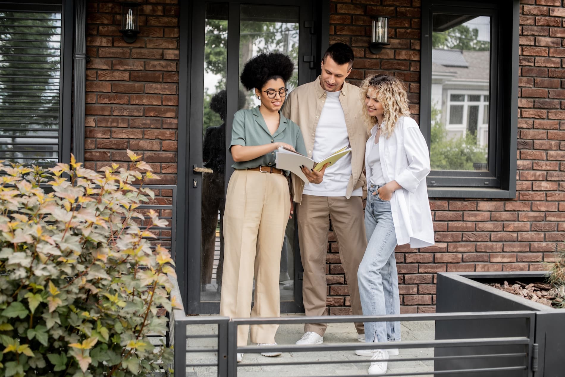People talking together outside a house.